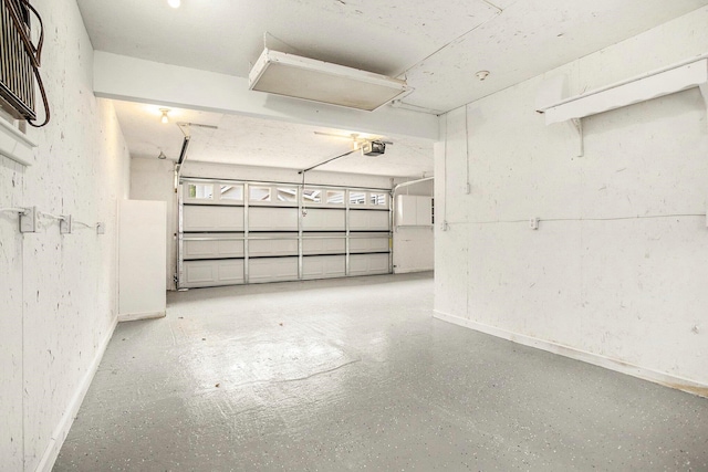 329 N Liberty St, Marshall, MI 49068 - garage with baseboards and a garage door opener