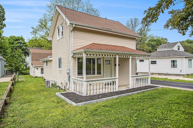 329 N Liberty St, Marshall, MI 49068 - view of front of home with covered porch, a front yard, and central AC unit
