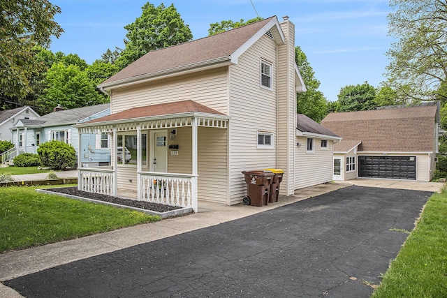329 N Liberty St, Marshall, MI 49068 - view of front facade with a porch, a chimney, and an outbuilding