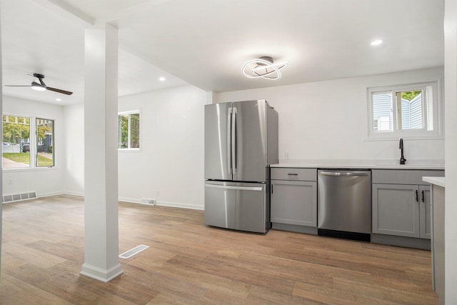 329 N Liberty St, Marshall, MI 49068 - kitchen featuring stainless steel appliances, gray cabinets, a sink, healthy amount of natural light, and recessed lighting