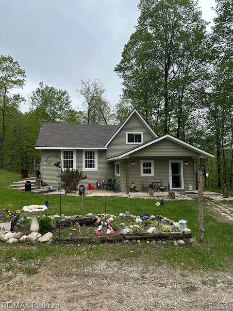 3624 Windy Hollow Rd NW, Rapid City, MI 49676 - view of front of home with a patio and a front lawn