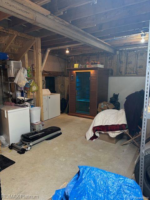 3624 Windy Hollow Rd NW, Rapid City, MI 49676 - unfinished below grade area with washing machine and dryer and refrigerator