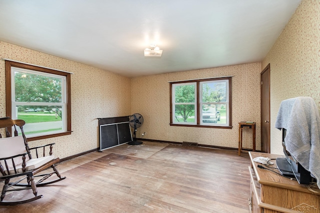 2430 S 4 Mile Rd, Kawkawlin, MI 48631 - sitting room with wallpapered walls, light wood-style floors, and healthy amount of natural light