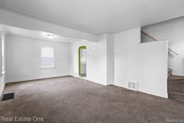 8492 Meadow Ave, Warren, MI 48089 - carpeted empty room featuring arched walkways, stairs, and baseboards