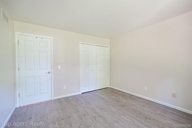 1676 Clemens Cir, Rochester Hills, MI 48307 - unfurnished bedroom with light wood-style flooring, baseboards, and a closet
