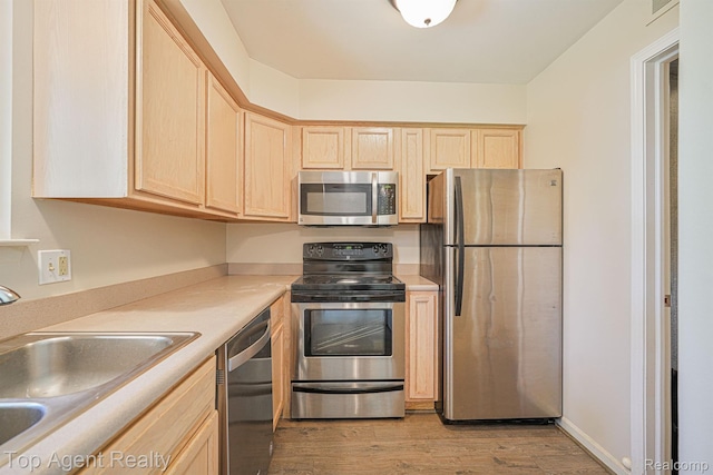 1676 Clemens Cir, Rochester Hills, MI 48307 - kitchen with appliances with stainless steel finishes, light brown cabinetry, a sink, and light wood finished floors