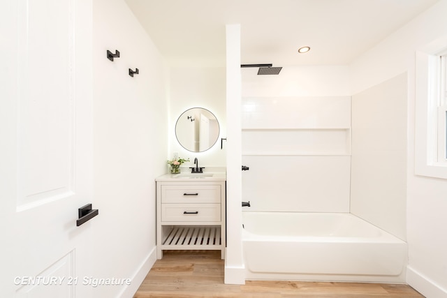 2705 Mccarty Rd, Saginaw, MI 48603 - full bath featuring wood finished floors, shower / tub combination, vanity, baseboards, and recessed lighting