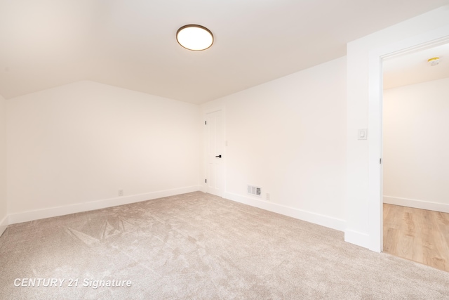 2705 Mccarty Rd, Saginaw, MI 48603 - unfurnished room featuring carpet floors, lofted ceiling, and baseboards