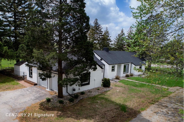 2705 Mccarty Rd, Saginaw, MI 48603 - single story home featuring asphalt driveway, a garage, a front yard, and roof with shingles
