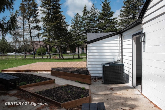 2705 Mccarty Rd, Saginaw, MI 48603 - view of yard featuring central air condition unit, a wooden deck, and a garden