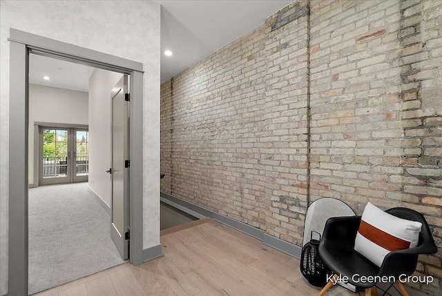 52 E 8th St Ste 210, Holland, MI 49423 - hallway with wood finished floors, brick wall, baseboards, and recessed lighting