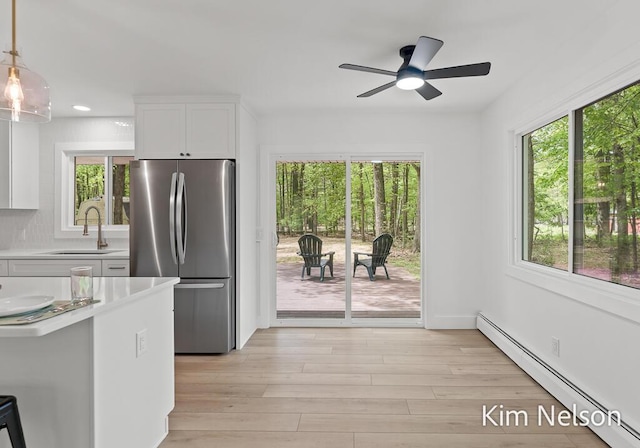 5203 Nestrom Rd, Whitehall, MI 49461 - kitchen with freestanding refrigerator, a sink, a baseboard radiator, healthy amount of natural light, and recessed lighting