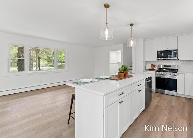 5203 Nestrom Rd, Whitehall, MI 49461 - kitchen with appliances with stainless steel finishes, light wood-style flooring, light countertops, and tasteful backsplash