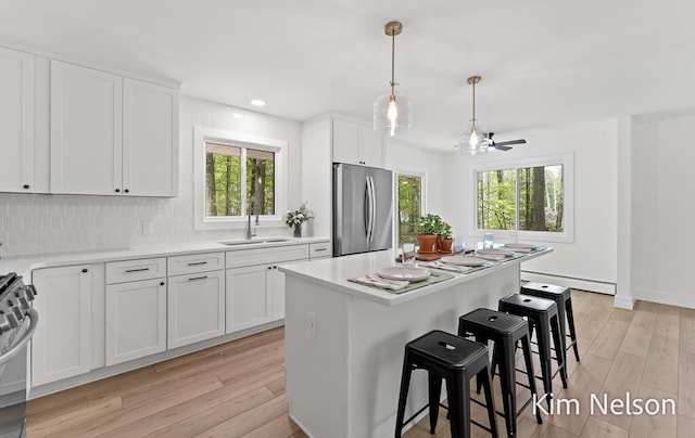 5203 Nestrom Rd, Whitehall, MI 49461 - kitchen with stainless steel appliances, baseboard heating, a sink, plenty of natural light, and recessed lighting