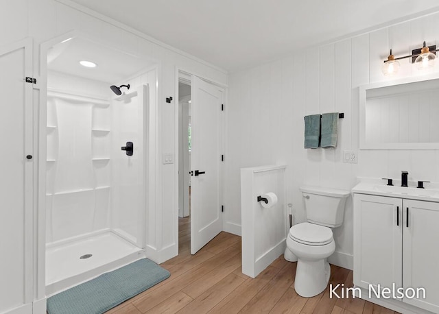 5203 Nestrom Rd, Whitehall, MI 49461 - full bath featuring wood finished floors, a walk in shower, toilet, and vanity
