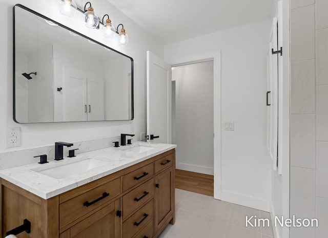 5203 Nestrom Rd, Whitehall, MI 49461 - bathroom with double vanity, baseboards, and tile patterned floors