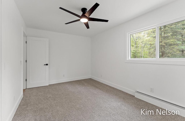 5203 Nestrom Rd, Whitehall, MI 49461 - carpeted empty room with a baseboard radiator, a ceiling fan, and baseboards
