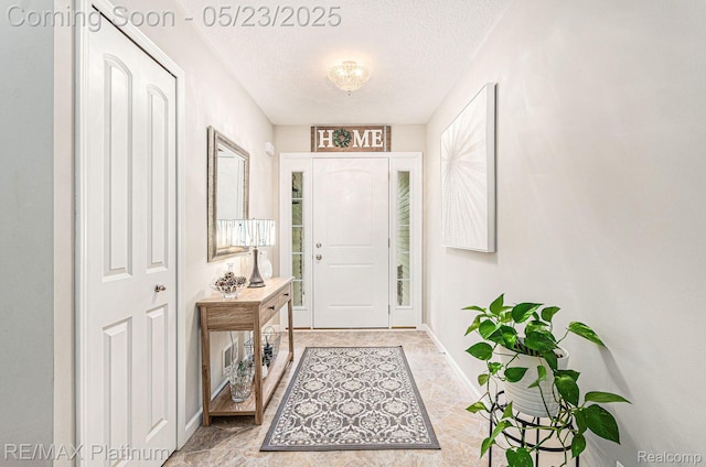 5956 Kerri Ln, Howell, MI 48855 - foyer with a textured ceiling and baseboards