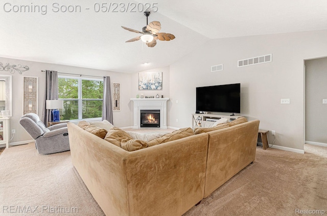 5956 Kerri Ln, Howell, MI 48855 - living room with ceiling fan, light colored carpet, a glass covered fireplace, vaulted ceiling, and baseboards