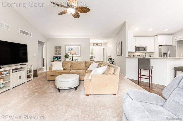 5956 Kerri Ln, Howell, MI 48855 - living area featuring a ceiling fan, light carpet, and lofted ceiling