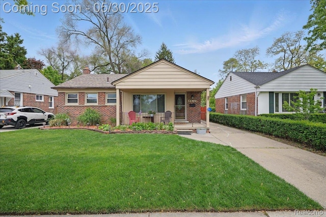 4412 Cooper Ave, Royal Oak, MI 48073 - view of front facade with brick siding, a porch, a front yard, and a chimney