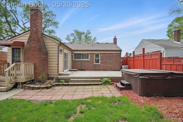 4412 Cooper Ave, Royal Oak, MI 48073 - rear view of house featuring a hot tub, a wooden deck, a chimney, brick siding, and a patio area