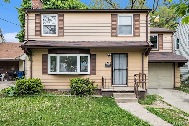 2952 Clement St, Flint, MI 48504 - view of front of house with a garage, a chimney, driveway, and a front yard
