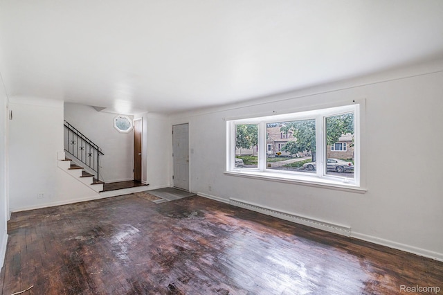 2952 Clement St, Flint, MI 48504 - foyer featuring a baseboard heating unit, wood finished floors, stairs, and baseboards