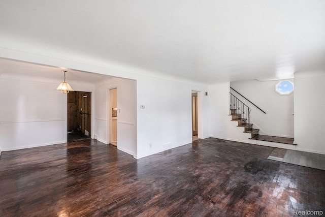 2952 Clement St, Flint, MI 48504 - unfurnished living room featuring dark wood-type flooring, stairs, and baseboards