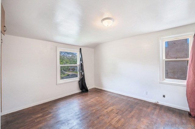 2952 Clement St, Flint, MI 48504 - empty room with dark wood-style flooring and baseboards