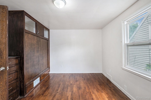 2952 Clement St, Flint, MI 48504 - unfurnished bedroom featuring dark wood-type flooring and baseboards