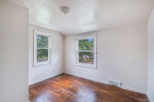 2952 Clement St, Flint, MI 48504 - empty room with wood finished floors, baseboards, and lofted ceiling