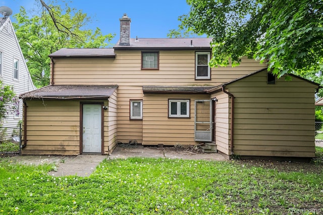 2952 Clement St, Flint, MI 48504 - rear view of property with a chimney and entry steps