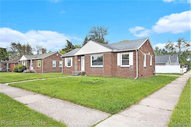 14620 Trenton Rd, Southgate, MI 48195 - bungalow-style home featuring brick siding, entry steps, and a front lawn