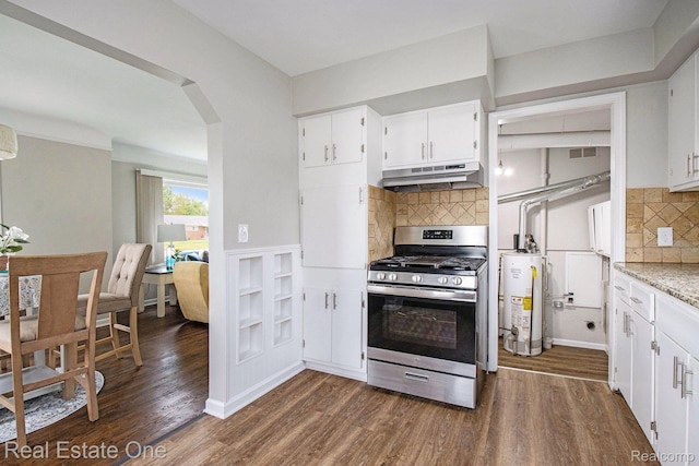 14620 Trenton Rd, Southgate, MI 48195 - kitchen with stainless steel range with gas stovetop, under cabinet range hood, water heater, arched walkways, and dark wood-style floors