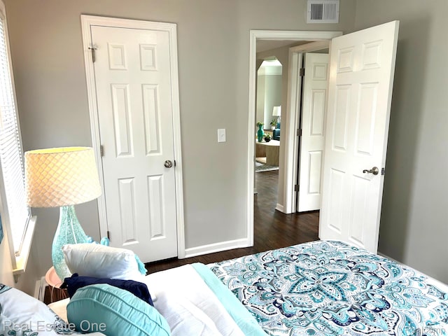 14620 Trenton Rd, Southgate, MI 48195 - bedroom with dark wood-type flooring, baseboards, and arched walkways