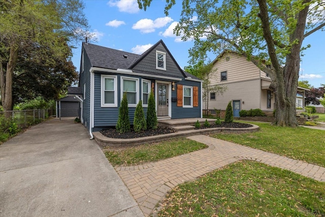 1437 Pearson St, Ferndale, MI 48220 - view of front of home with an outbuilding, a garage, and a shingled roof