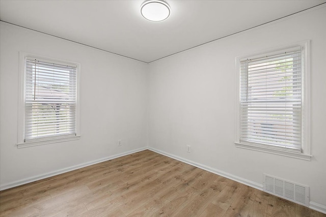 1437 Pearson St, Ferndale, MI 48220 - spare room with light wood finished floors, baseboards, and healthy amount of natural light