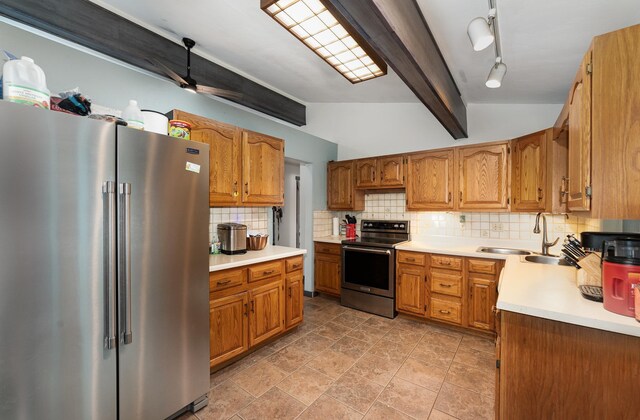 812 W Center, Alma, MI 48880 - kitchen with appliances with stainless steel finishes, a sink, backsplash, light countertops, and brown cabinets