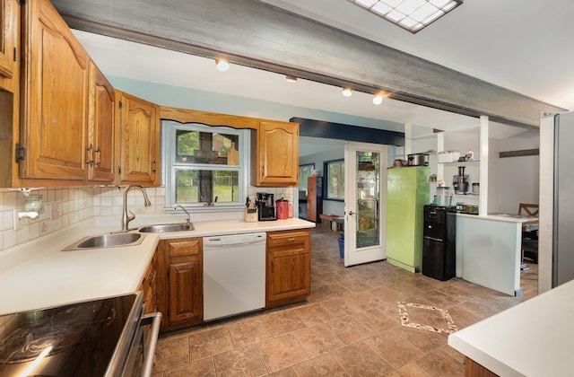 812 W Center, Alma, MI 48880 - kitchen with white dishwasher, stainless steel range with electric stovetop, a sink, decorative backsplash, and light countertops