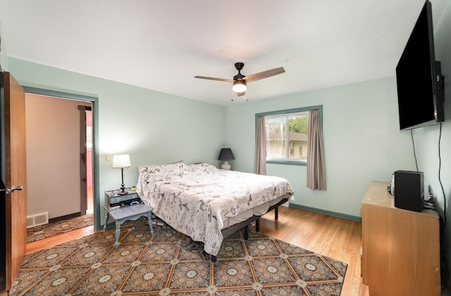 812 W Center, Alma, MI 48880 - bedroom with wood finished floors, ceiling fan, and baseboards