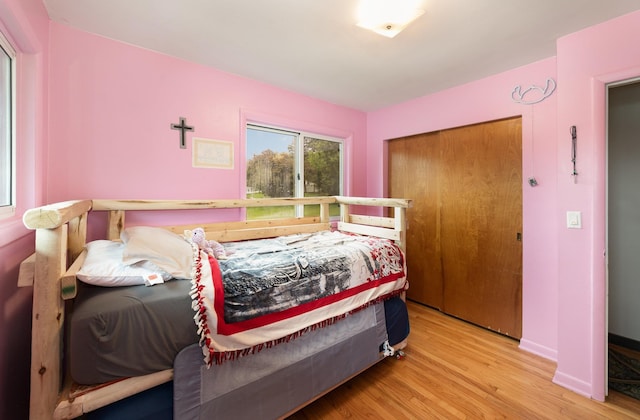 812 W Center, Alma, MI 48880 - bedroom with wood finished floors, a closet, and baseboards