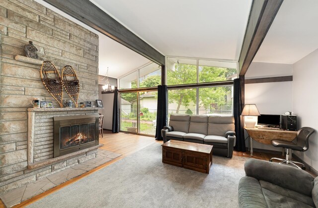 812 W Center, Alma, MI 48880 - carpeted living room featuring a fireplace, an office area, and a chandelier