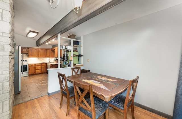 812 W Center, Alma, MI 48880 - dining space with vaulted ceiling and light wood-type flooring