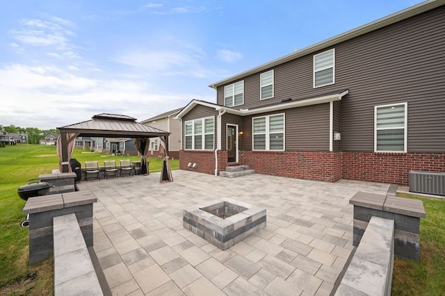 2610 Ironton Dr, Commerce Twp, MI 48382 - back of house featuring a gazebo, a patio, brick siding, and a fire pit