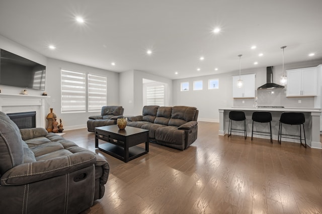 2610 Ironton Dr, Commerce Twp, MI 48382 - living area with baseboards, recessed lighting, dark wood-style flooring, and a premium fireplace