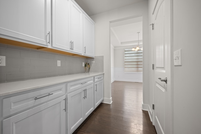 2610 Ironton Dr, Commerce Twp, MI 48382 - hall with dark wood-type flooring, a chandelier, and baseboards