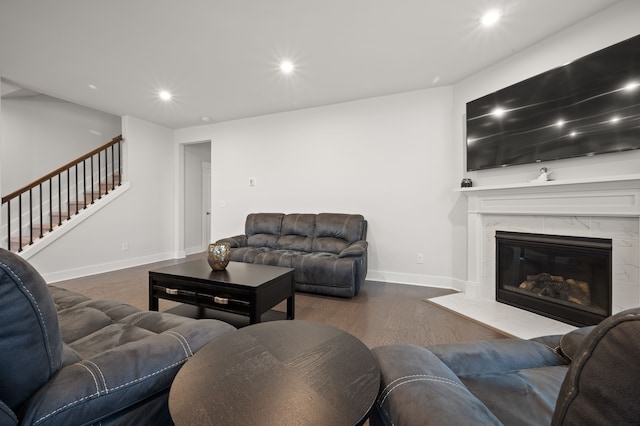 2610 Ironton Dr, Commerce Twp, MI 48382 - living area with wood finished floors, stairs, recessed lighting, baseboards, and a premium fireplace