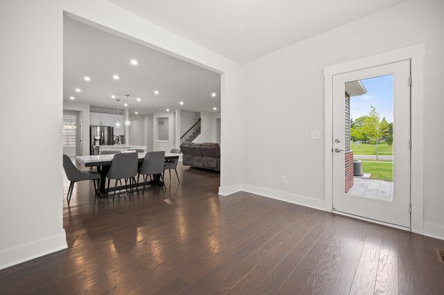 2610 Ironton Dr, Commerce Twp, MI 48382 - dining space with stairs, plenty of natural light, dark wood finished floors, baseboards, and recessed lighting