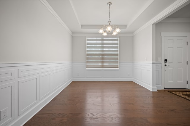2610 Ironton Dr, Commerce Twp, MI 48382 - unfurnished dining area with a chandelier, a tray ceiling, dark wood-style flooring, a wainscoted wall, and crown molding